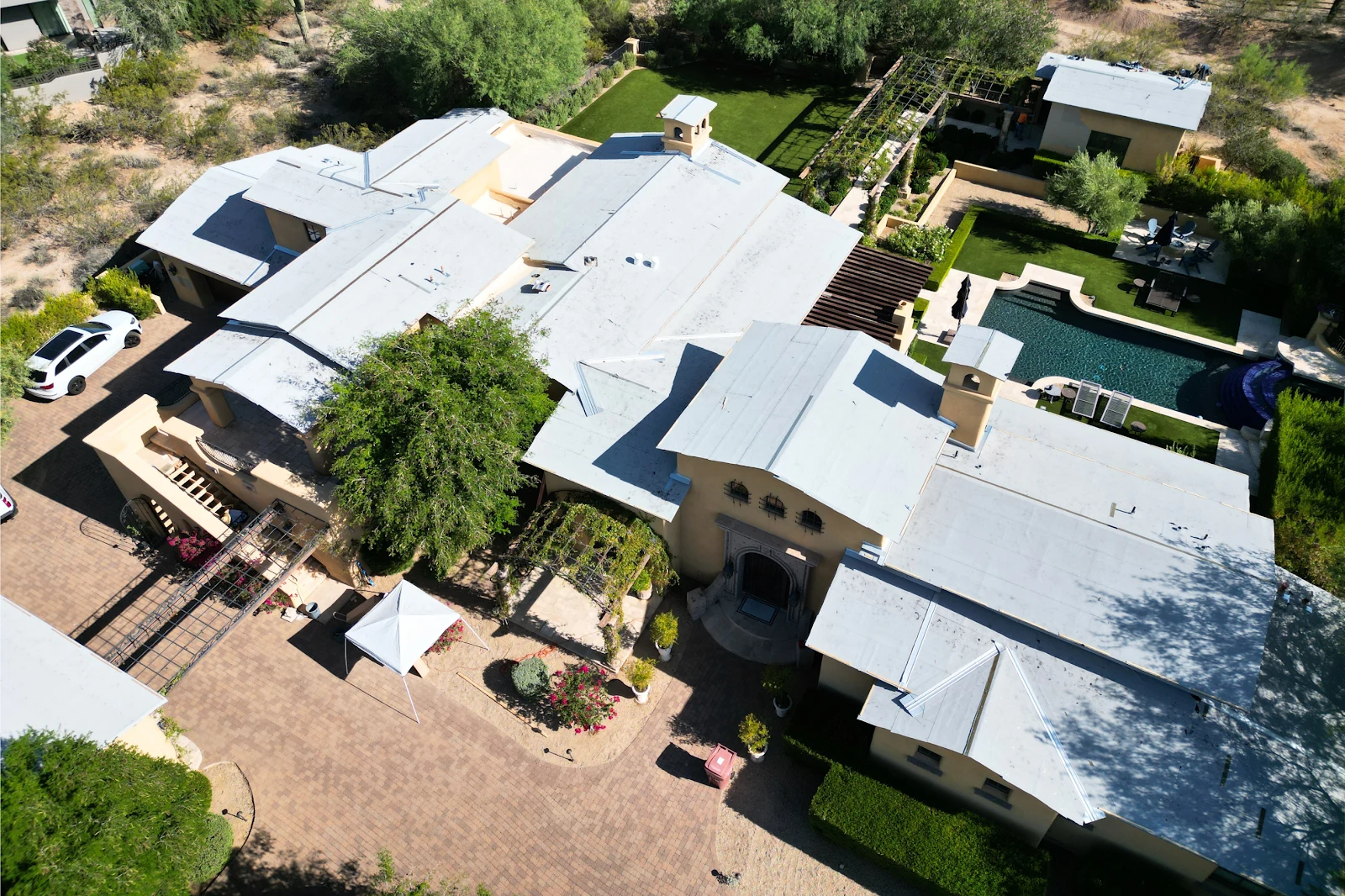 Aerial view of a large home with new underlayment across the roof