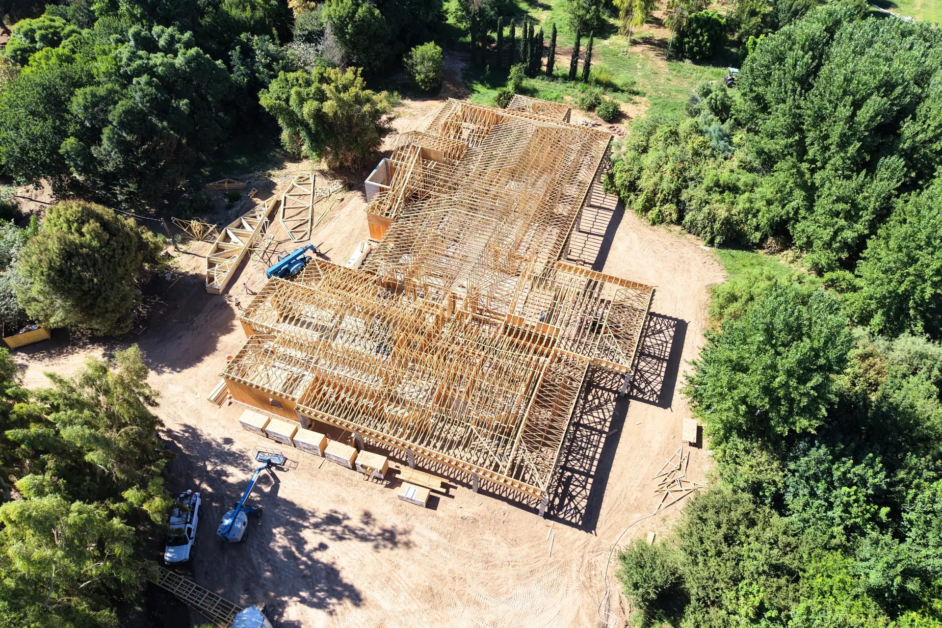 Truss framing in progress on a big custom home