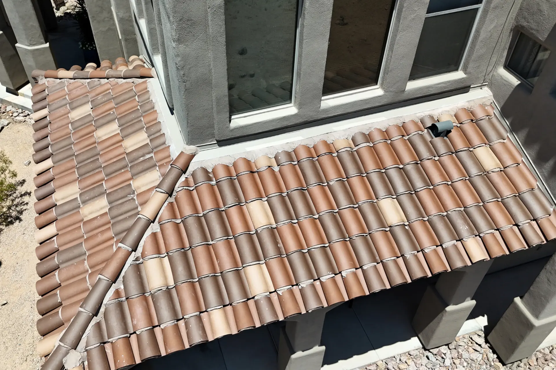 Clay barrel tile roofing over a bay window overhang