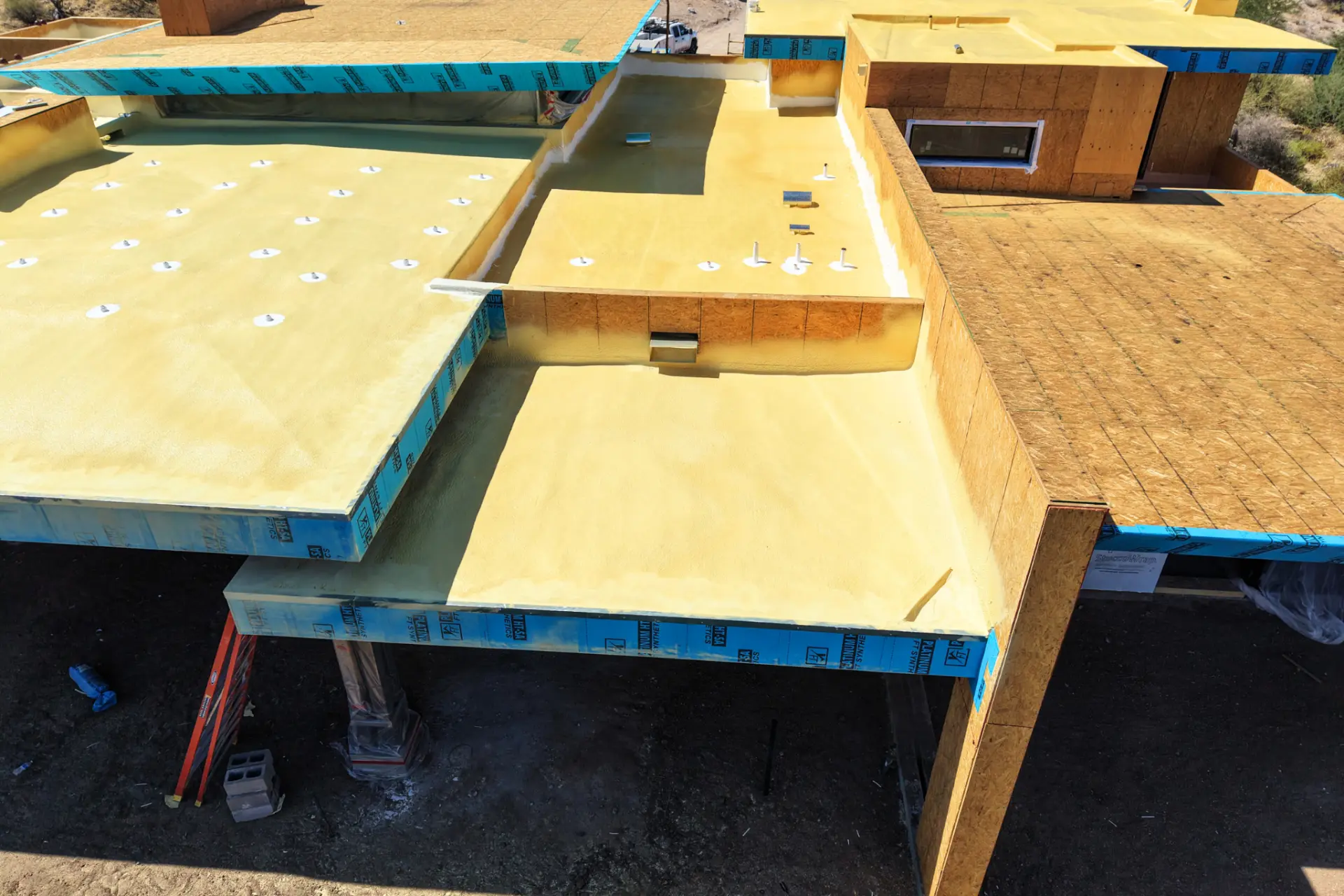 Spray foam roof installed across multiple flat roof sections
