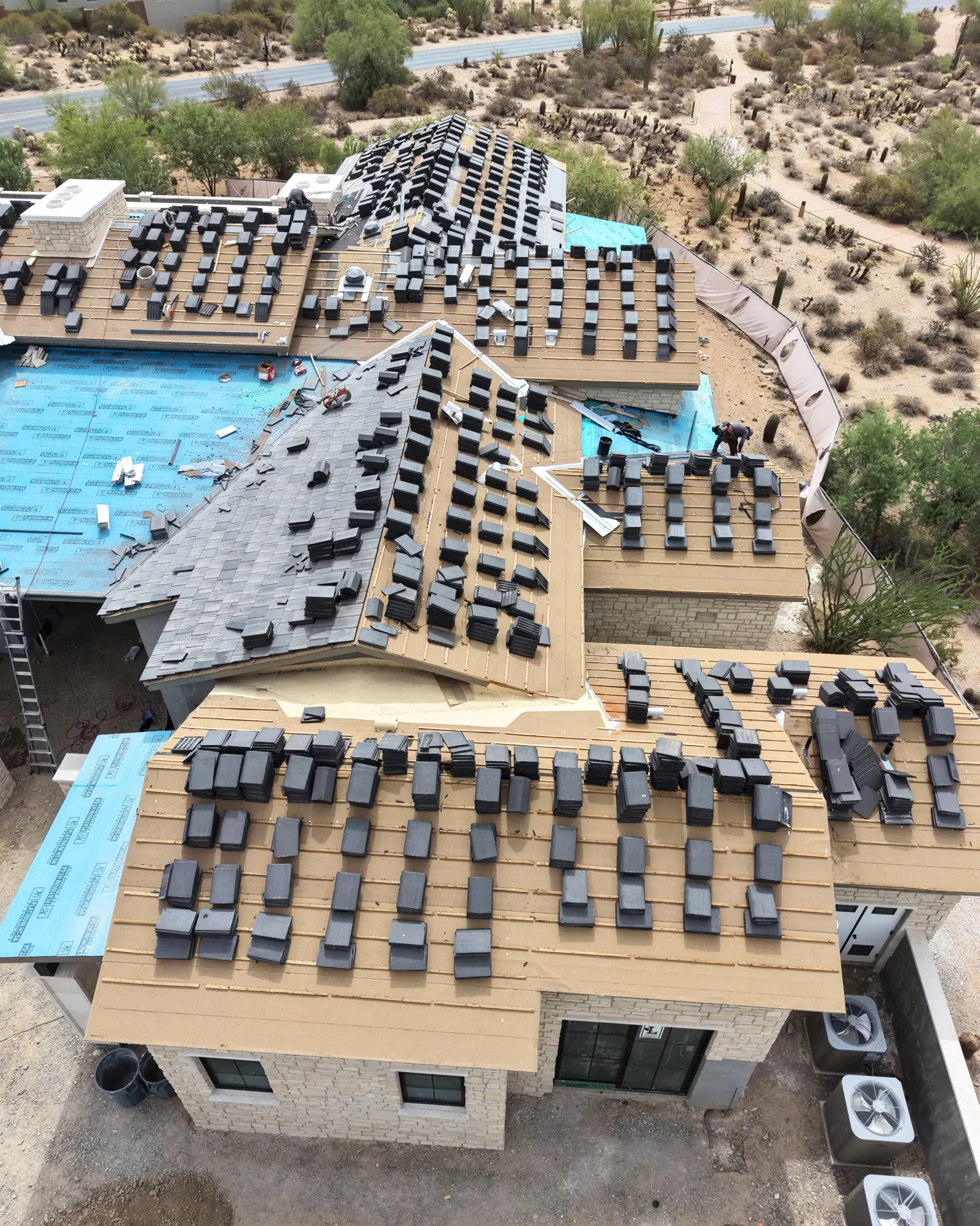 Stacked concrete tile loaded out across a new roof deck