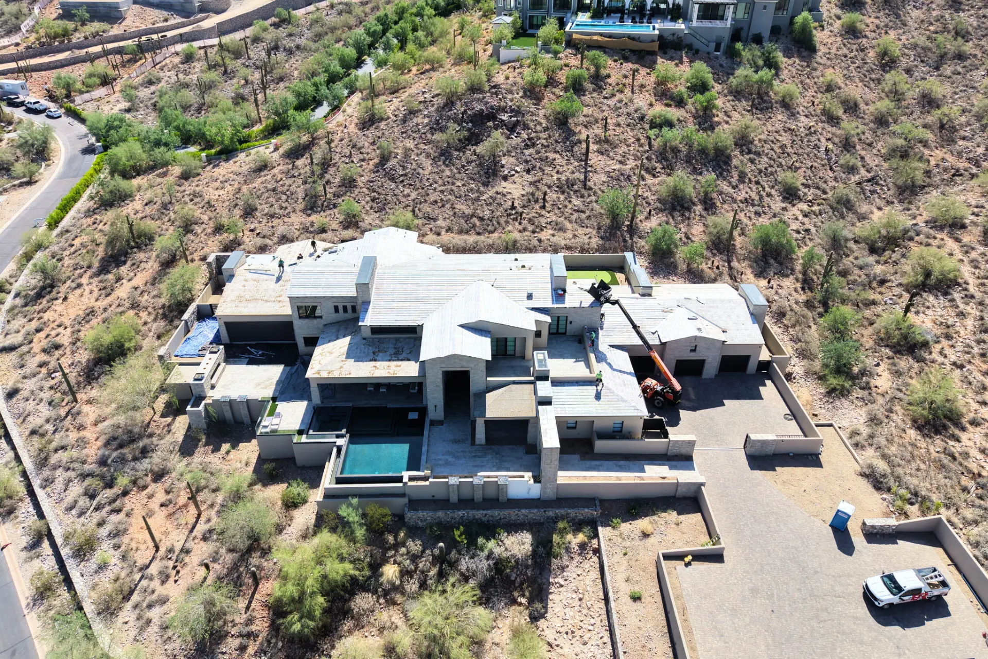 Roofing crew working a hillside luxury home in Paradise Valley